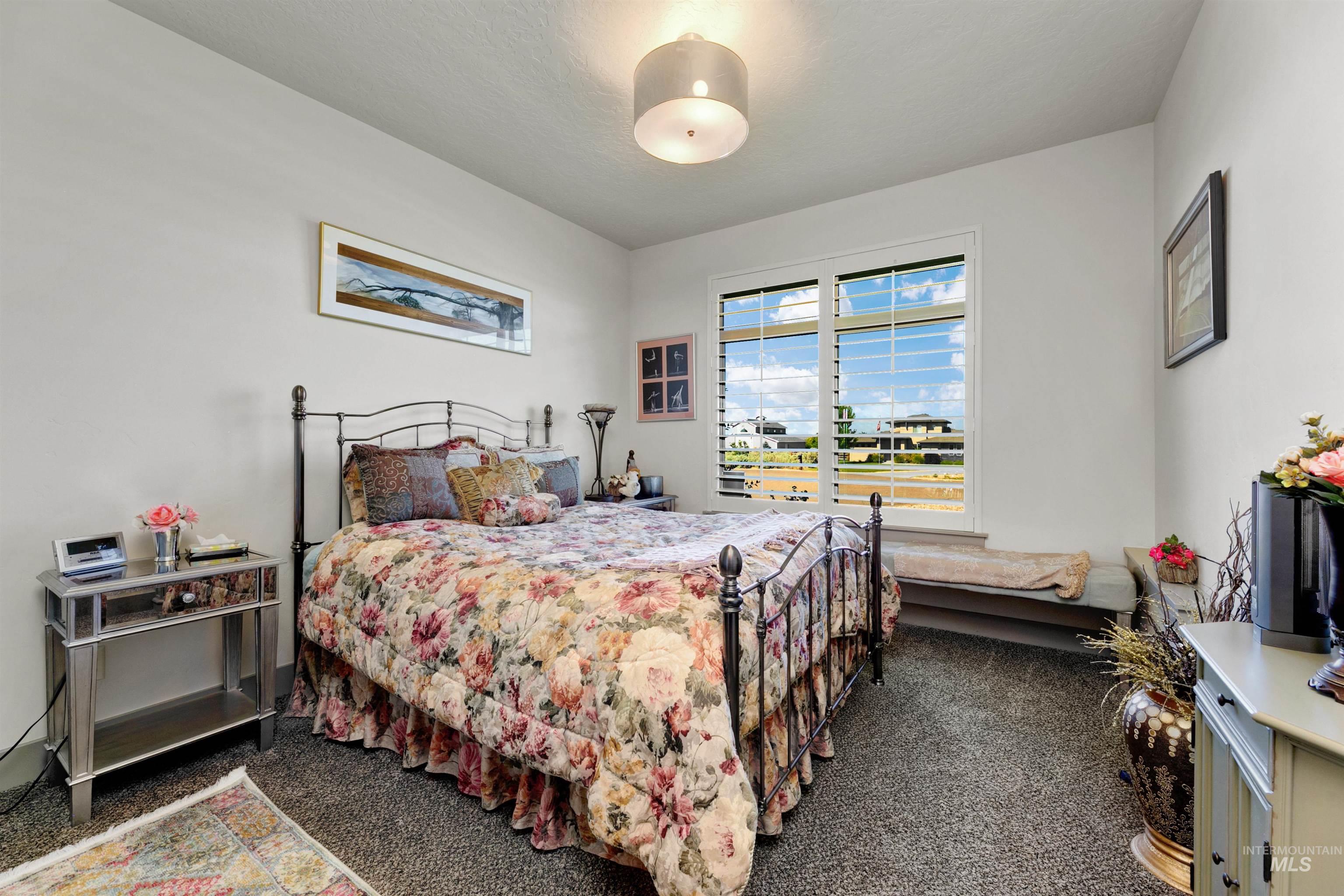 24398 Tombstone Ridge Court Middleton, ID 83644 - Photo 13 of 47 Carpeted room with a large window featuring white plantation shutters