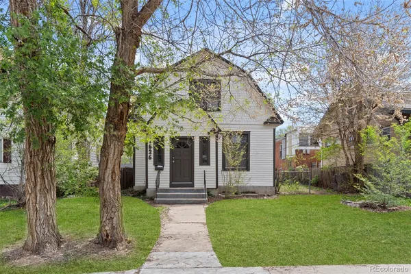 a front view of house with a garden