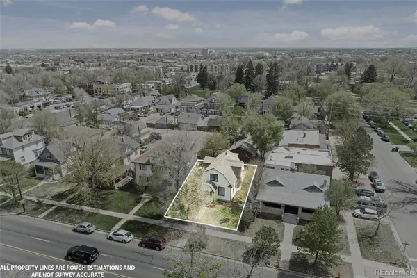 an aerial view of residential houses with city view