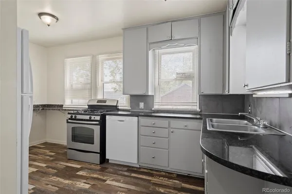 a kitchen with a sink stove and cabinets