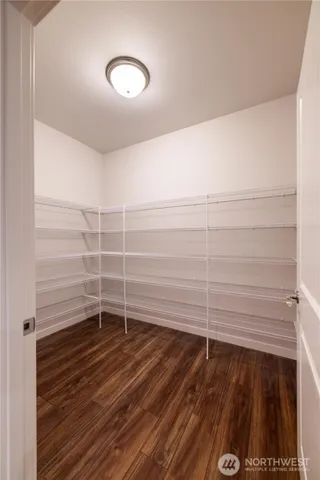 a view of a room with wooden floor and white walls
