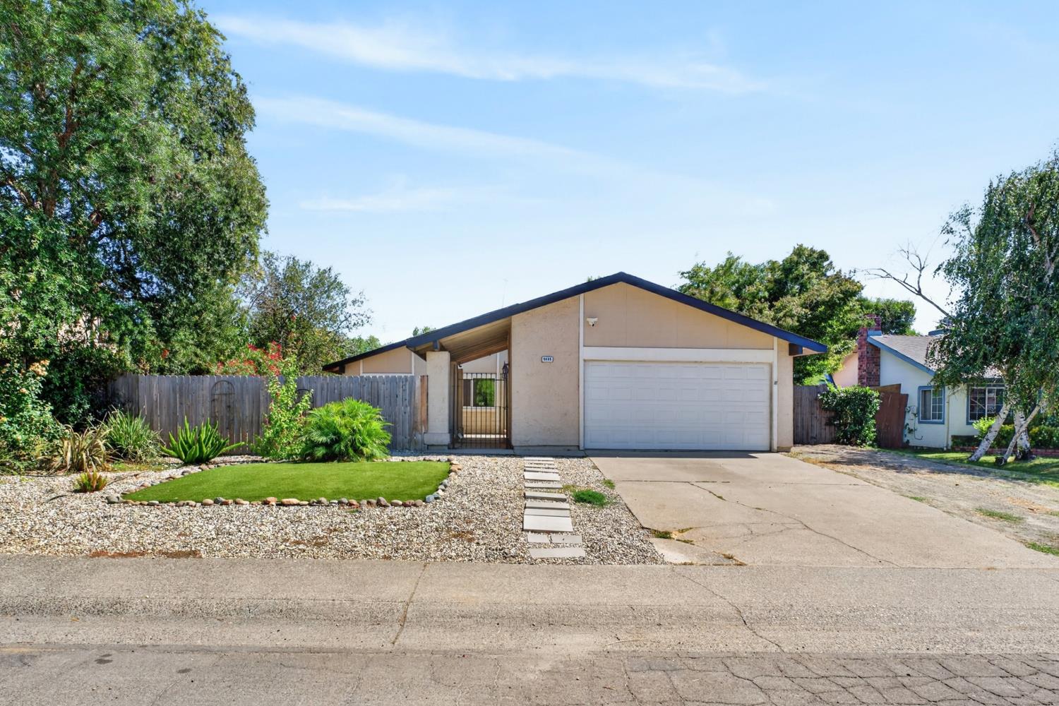 8488 Old Ranch Road Orangevale, CA 95662 - Photo 1 of 51 a front view of a house with a yard and potted plants