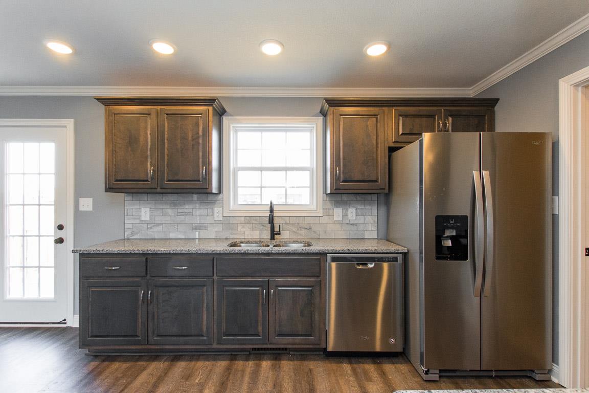 2316 Pea Ridge Road Clarksville, TN 37040 - Photo 13 of 30 a kitchen with stainless steel appliances granite countertop a refrigerator a sink and wooden cabinets