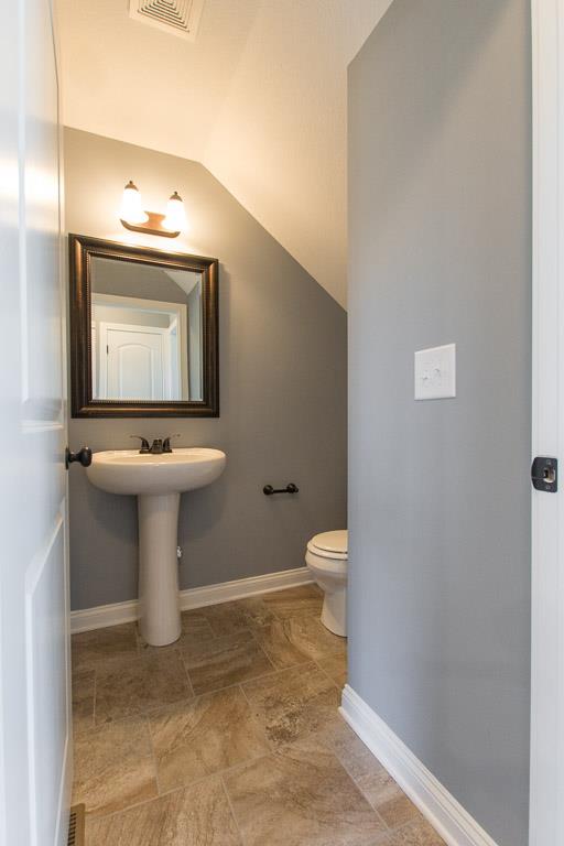 2316 Pea Ridge Road Clarksville, TN 37040 - Photo 18 of 30 a bathroom with a toilet sink and mirror