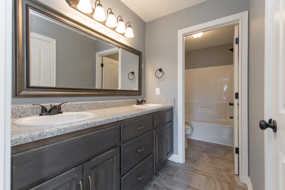 2316 Pea Ridge Road Clarksville, TN 37040 - Photo 23 of 30 a bathroom with a granite countertop sink mirror and a