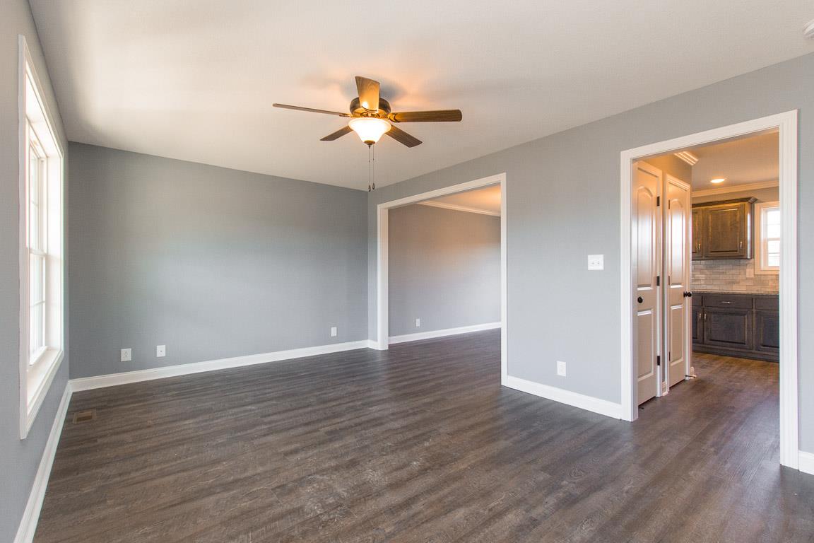2316 Pea Ridge Road Clarksville, TN 37040 - Photo 6 of 30 a view of an empty room with a window and wooden floor
