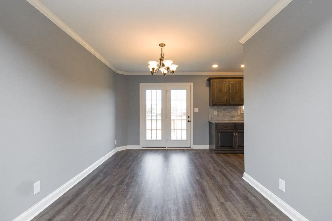 2316 Pea Ridge Road Clarksville, TN 37040 - Photo 10 of 30 a view of an empty room with wooden floor and a window