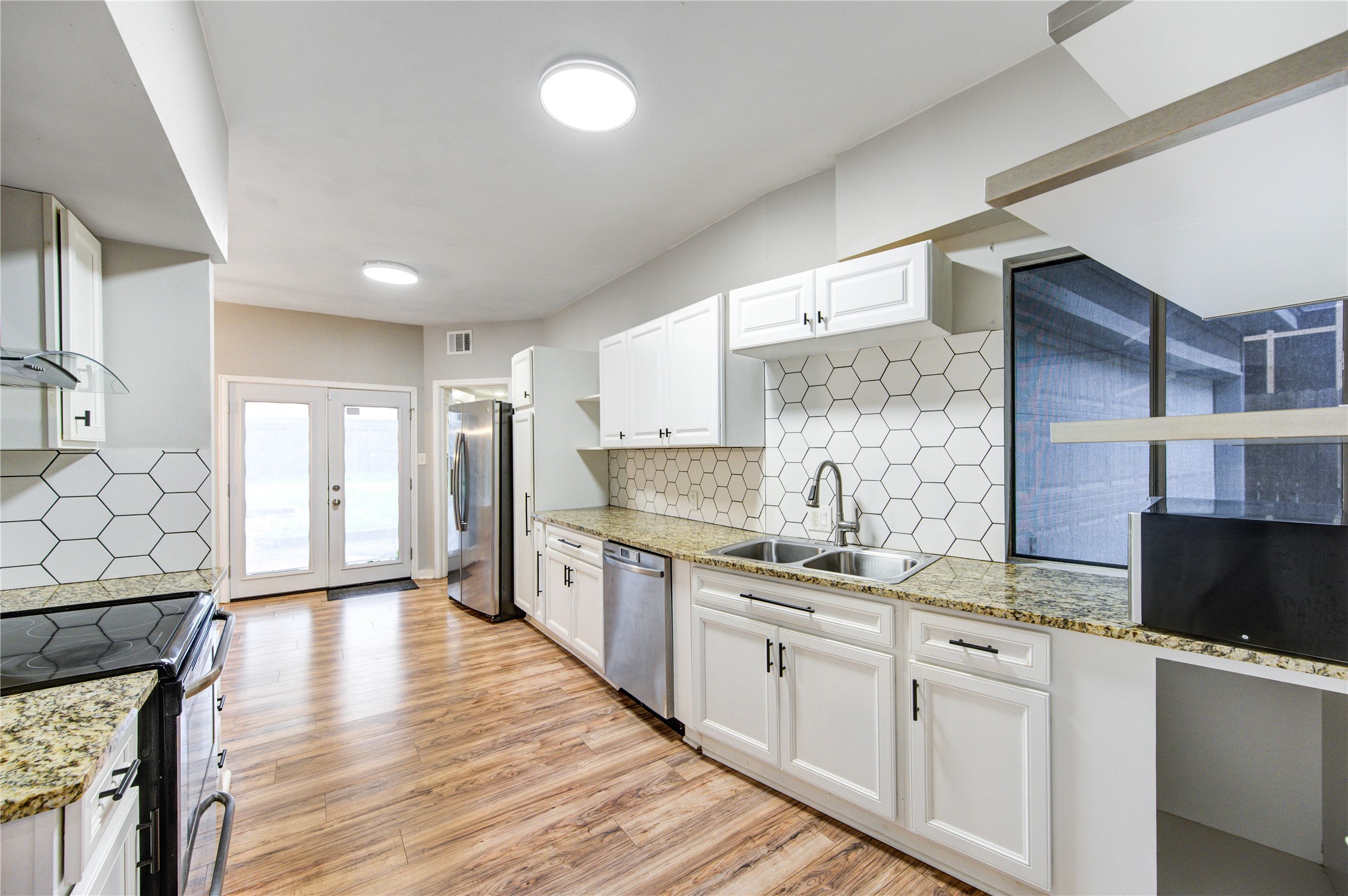 530 Enchanted Lane Spring, TX 77388 - Photo 9 of 26 a kitchen with stainless steel appliances granite countertop a sink stove and refrigerator