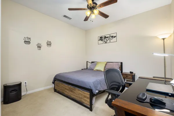 a room with lots of tables a large window and chairs