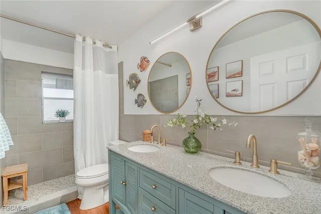 a bathroom with 2 sink and a mirror