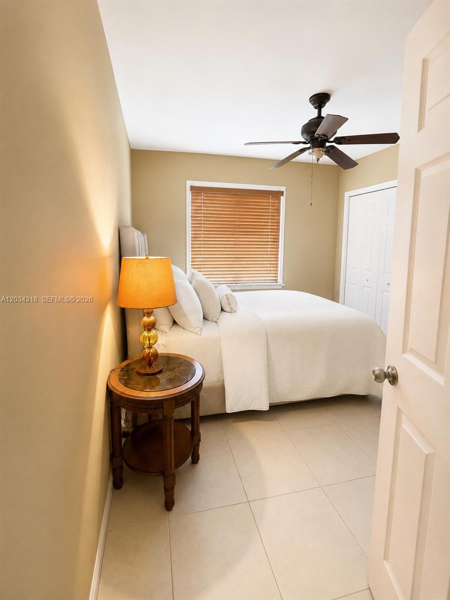 14856 Southwest 179th Street Miami, FL 33187 - Photo 21 of 33 a bedroom with a bed and a chandelier