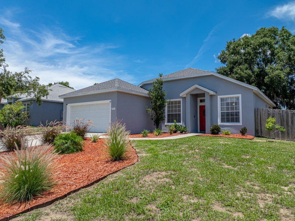 411 Ryans Ridge Avenue Eustis, FL 32726 - Photo 1 of 1 a front view of a house with a yard and porch