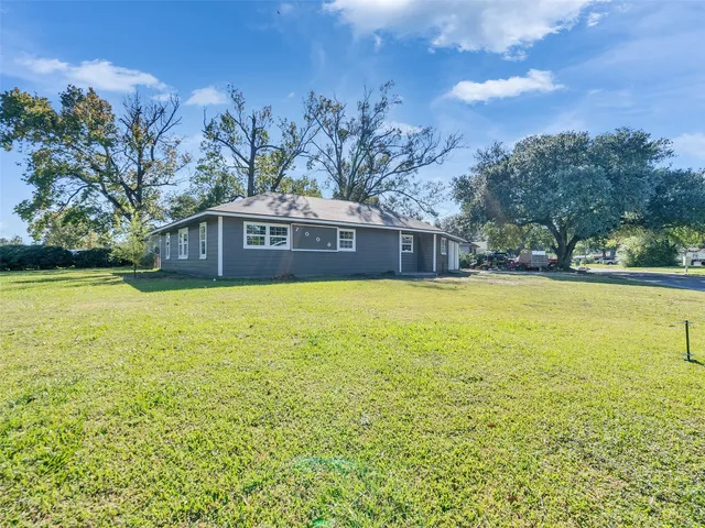 a view of a house with swimming pool and a yard