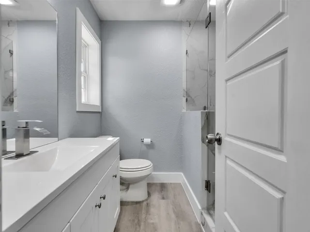 a bathroom with a sink toilet and vanity