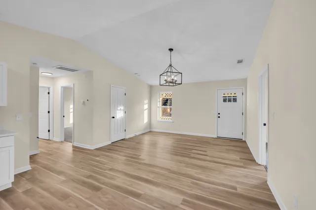 a living room with furniture a fireplace and a chandelier