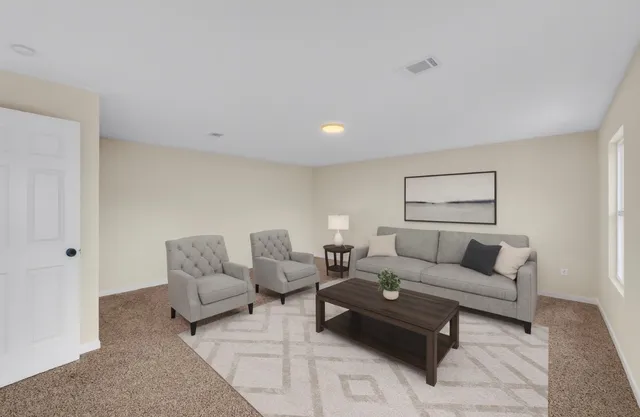 a bedroom with a bed and a night stand