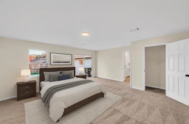 a bedroom with a bed and a window