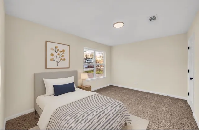 a view of a room with wooden floor and white walls