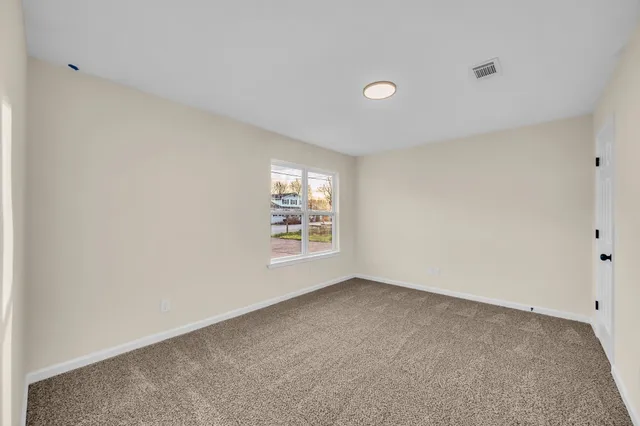 a bathroom with a sink a toilet a mirror and shower