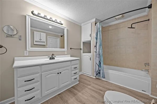 a bathroom with a granite countertop sink toilet a mirror a vanity and shower
