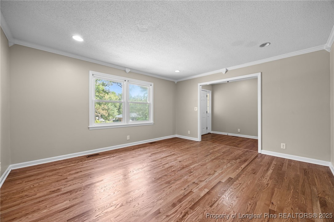58 Eagle Road Coats, NC 27521 - Photo 16 of 49 an empty room with wooden floor and window