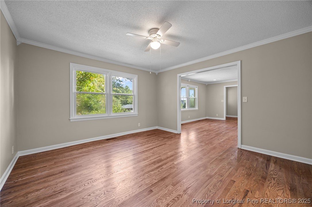 58 Eagle Road Coats, NC 27521 - Photo 18 of 49 a view of an empty room with wooden floor and a window