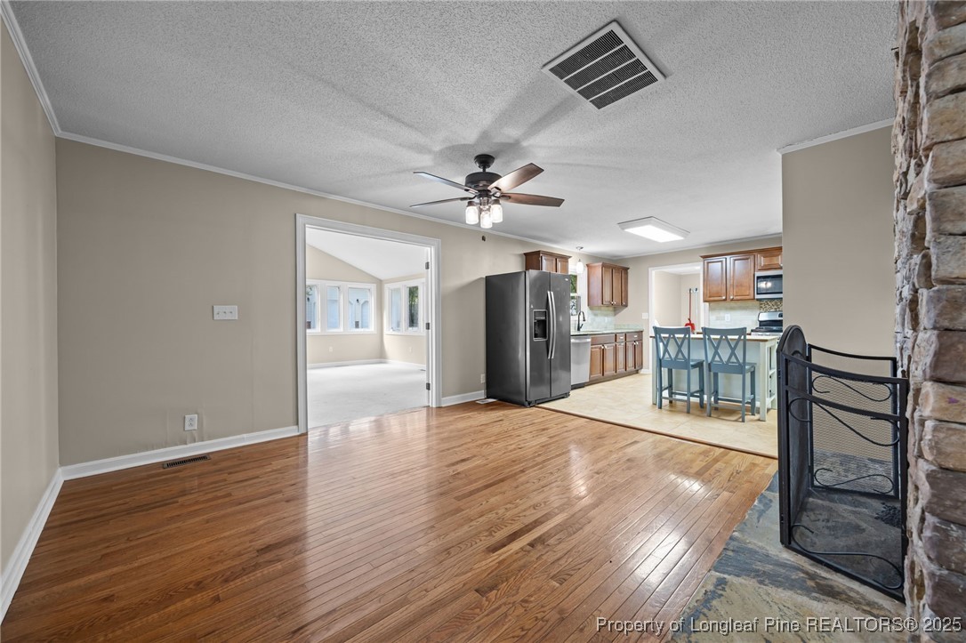 58 Eagle Road Coats, NC 27521 - Photo 19 of 49 wooden floor in an empty room with a fireplace