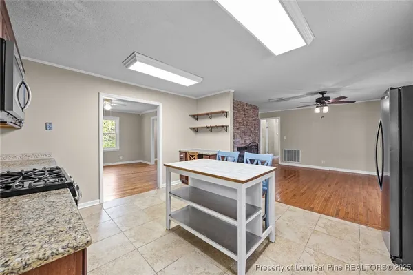 a kitchen with a stove and a refrigerator