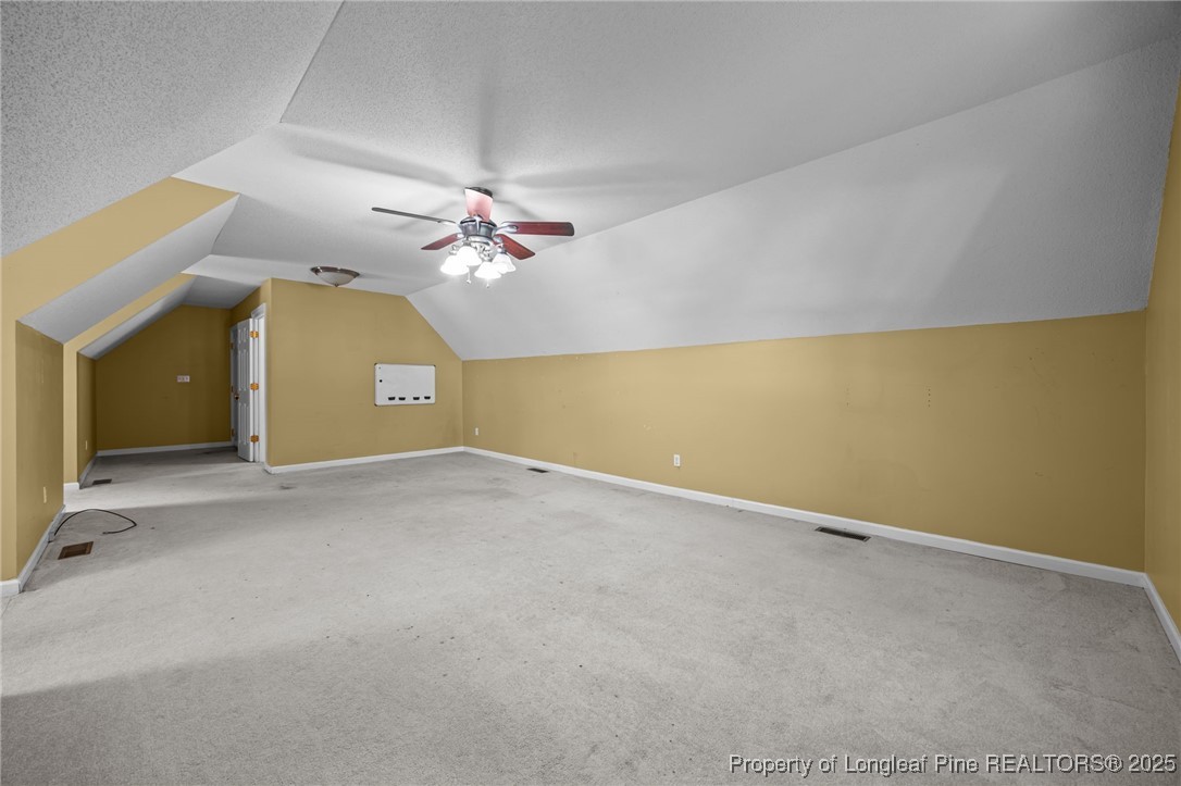 58 Eagle Road Coats, NC 27521 - Photo 33 of 49 an empty room with a chandelier fan and a large window