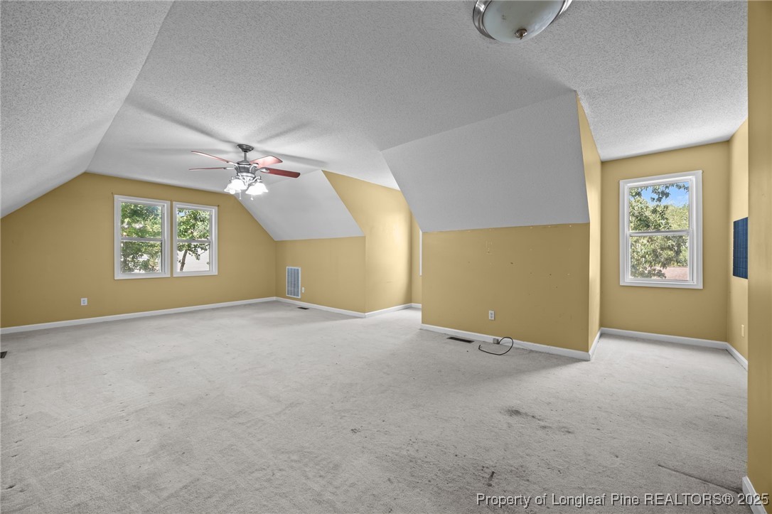 58 Eagle Road Coats, NC 27521 - Photo 34 of 49 an empty room with windows and chandelier fan