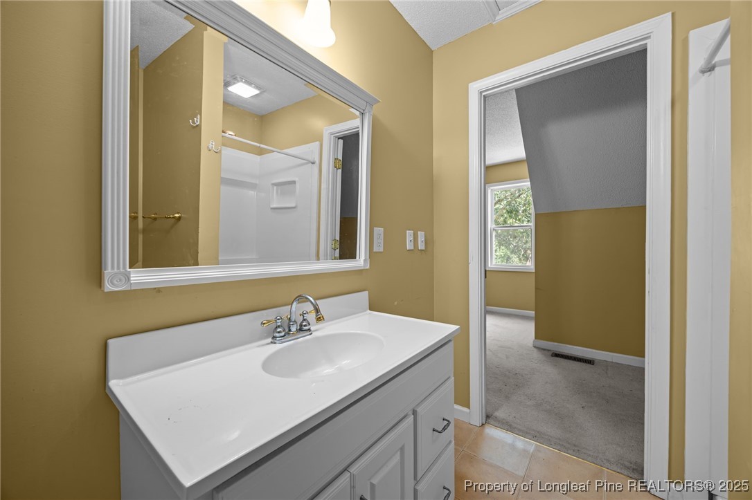 58 Eagle Road Coats, NC 27521 - Photo 35 of 49 a bathroom with a sink and a mirror