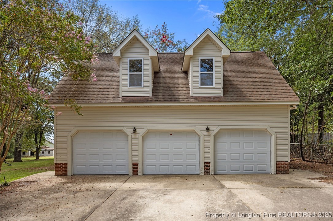 58 Eagle Road Coats, NC 27521 - Photo 37 of 49 a view of a house with a yard and garage