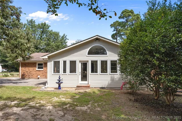 a house view with a sitting space and garden