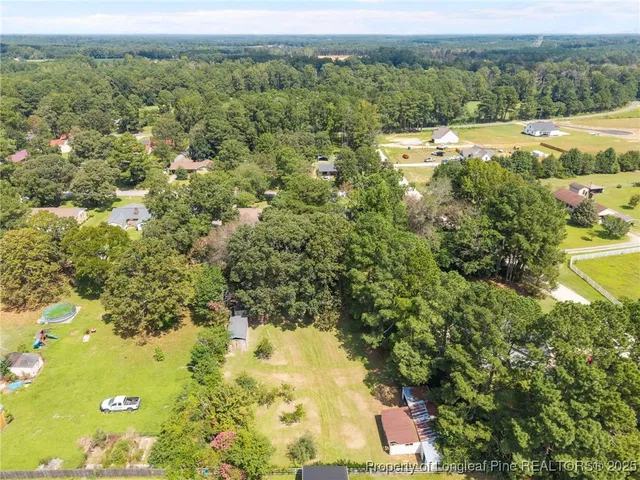 an aerial view of residential house with outdoor space and swimming pool