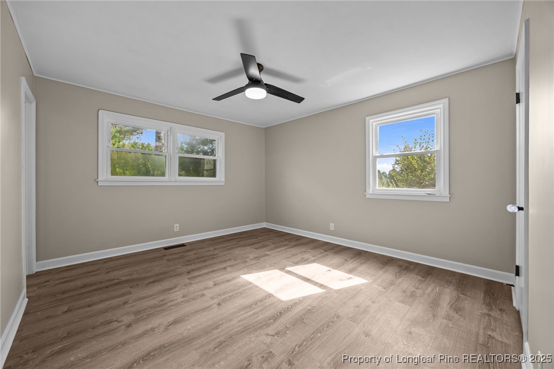 58 Eagle Road Coats, NC 27521 - Photo 6 of 49 a view of an empty room with wooden floor and a window