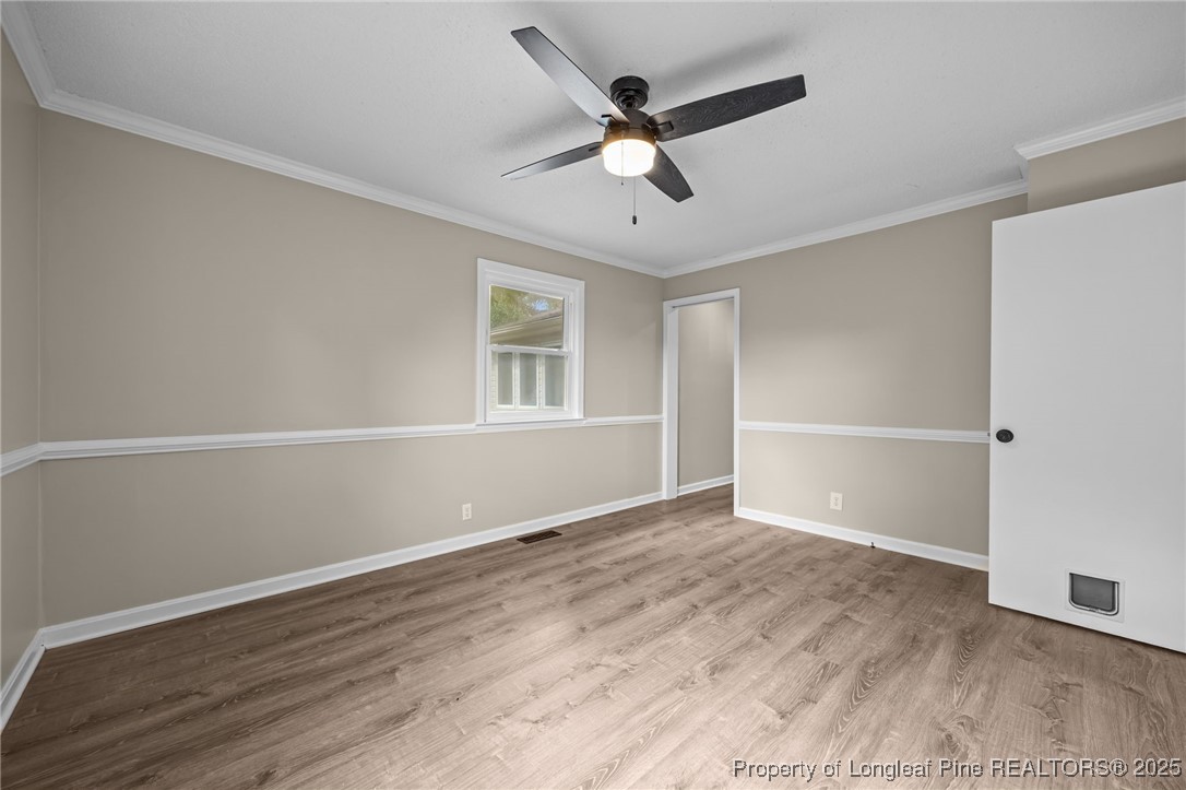 58 Eagle Road Coats, NC 27521 - Photo 9 of 49 an empty room with wooden floor and windows