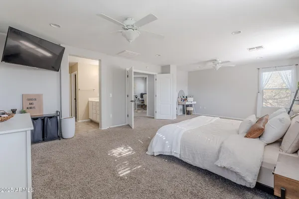 a bedroom with a bed and a chandelier