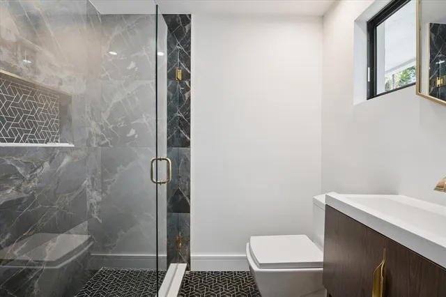 a bathroom with a toilet and a shower