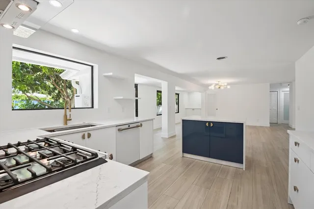 a kitchen with stainless steel appliances granite countertop a stove a sink and a refrigerator