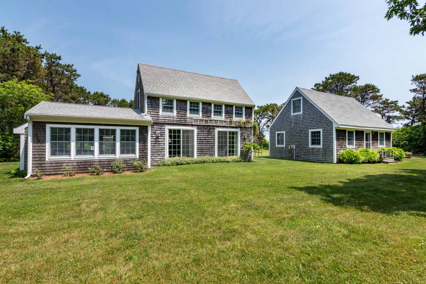 1 Garden Cove Road Edgartown, MA 02539 - Photo 2 of 37 a front view of a house with a garden