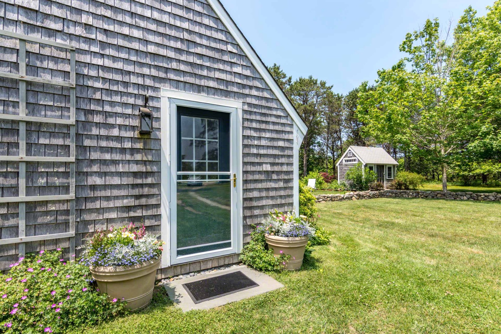 1 Garden Cove Road Edgartown, MA 02539 - Photo 37 of 37 a front view of a house with a yard and fountain