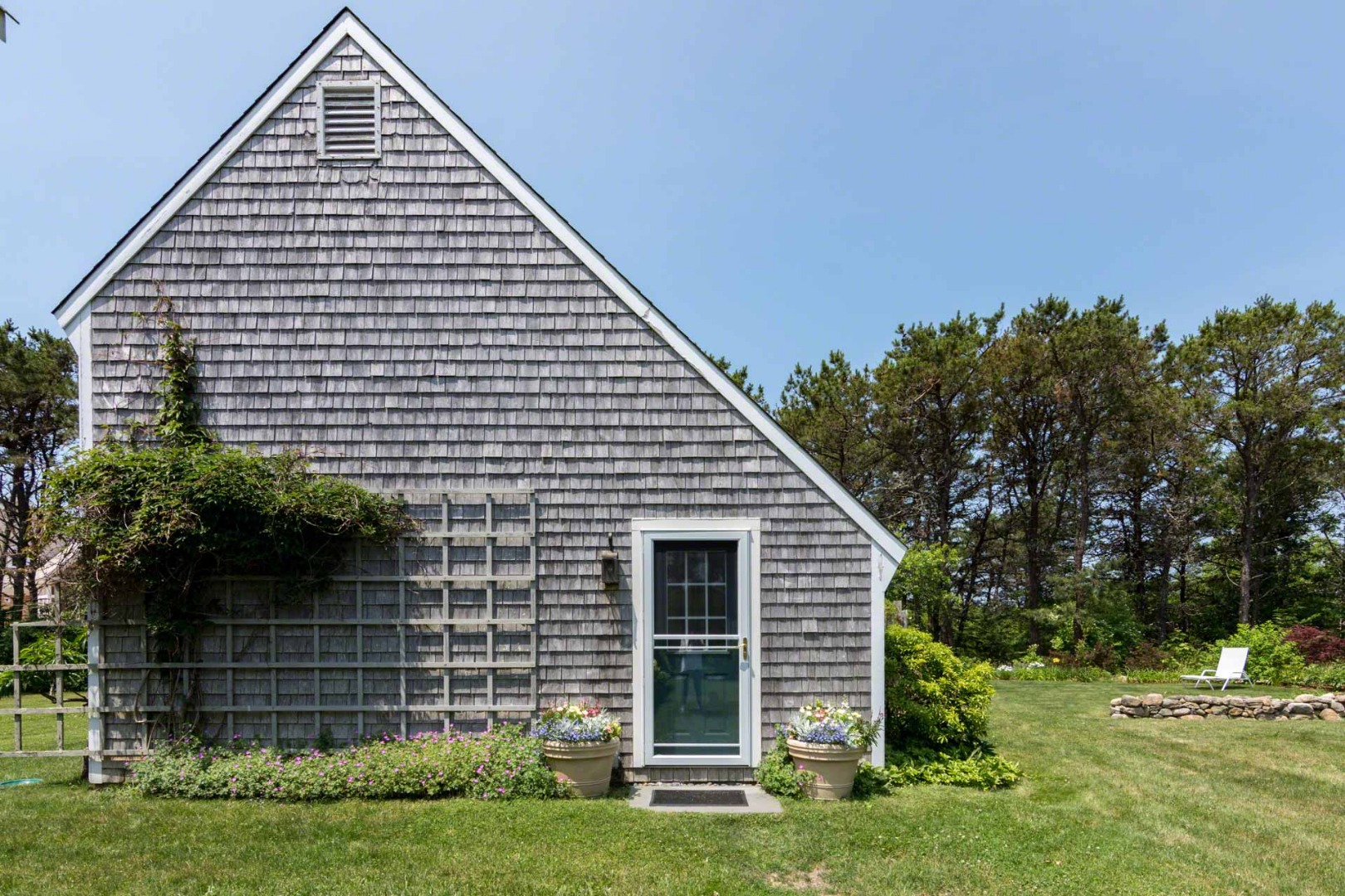 1 Garden Cove Road Edgartown, MA 02539 - Photo 5 of 37 a front view of a house with a yard