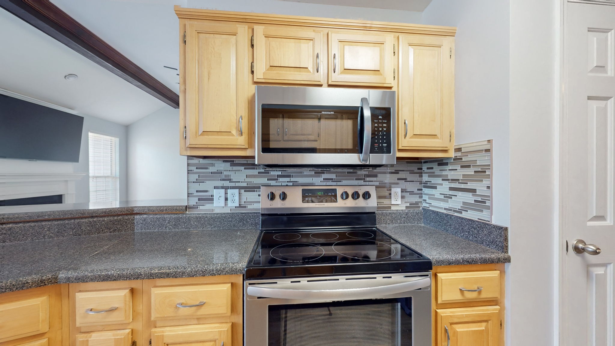 500 Sheath Circle Lebanon, TN 37087 - Photo 17 of 29 a kitchen with granite countertop stainless steel appliances a stove a microwave and cabinets