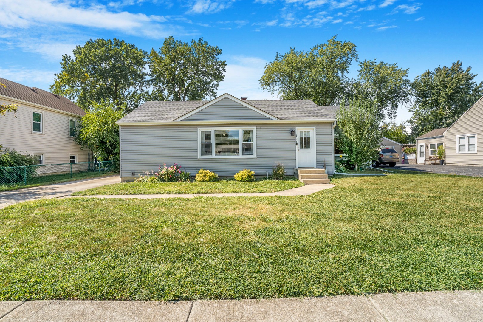 7510 Thomas Avenue Bridgeview, IL 60455 - Photo 3 of 25 a front view of house with yard and trees in the background