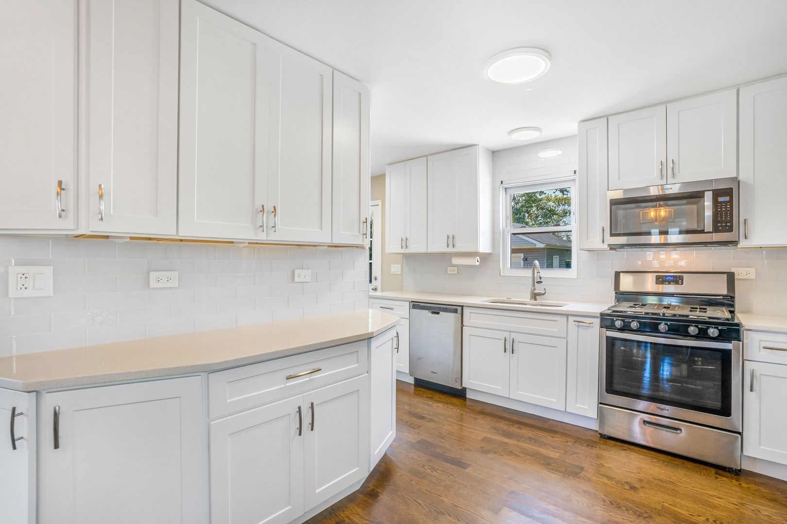 7510 Thomas Avenue Bridgeview, IL 60455 - Photo 7 of 25 a kitchen with white cabinets and appliances
