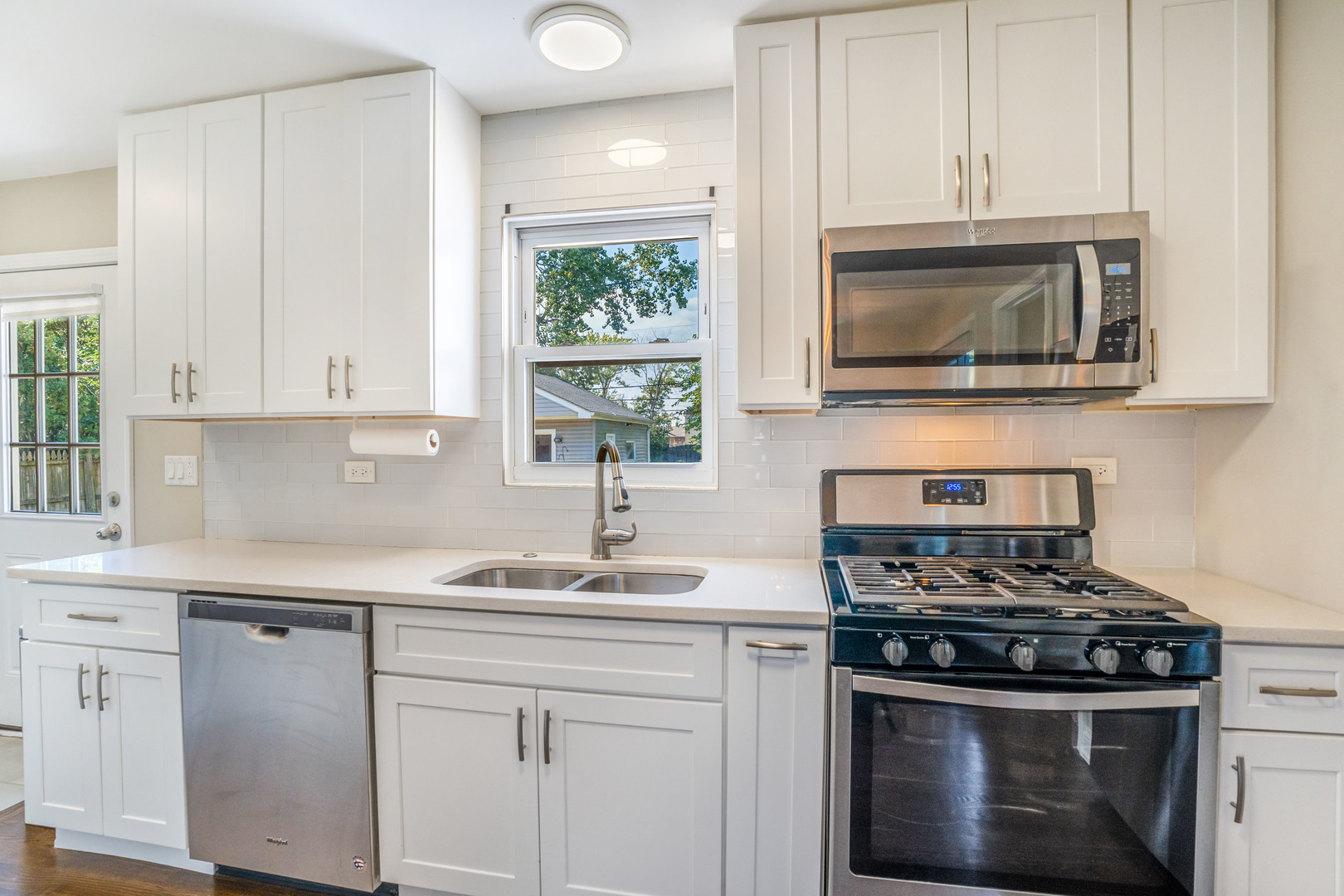7510 Thomas Avenue Bridgeview, IL 60455 - Photo 8 of 25 a kitchen with stainless steel appliances granite countertop white cabinets a stove a sink and a white wooden cabinets