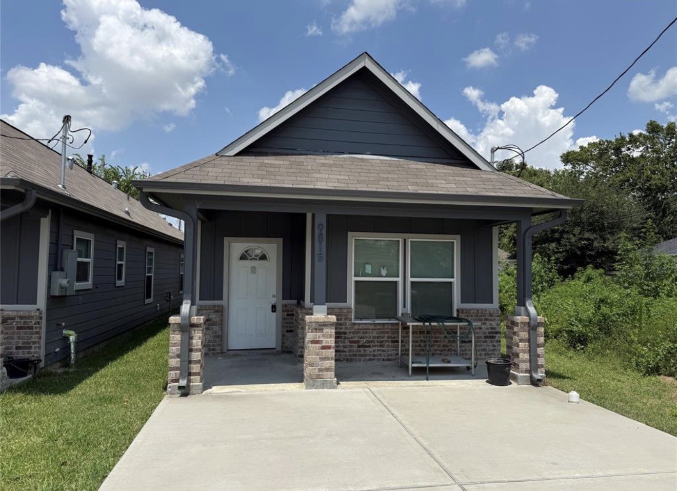 a front view of a house with a garden and plants