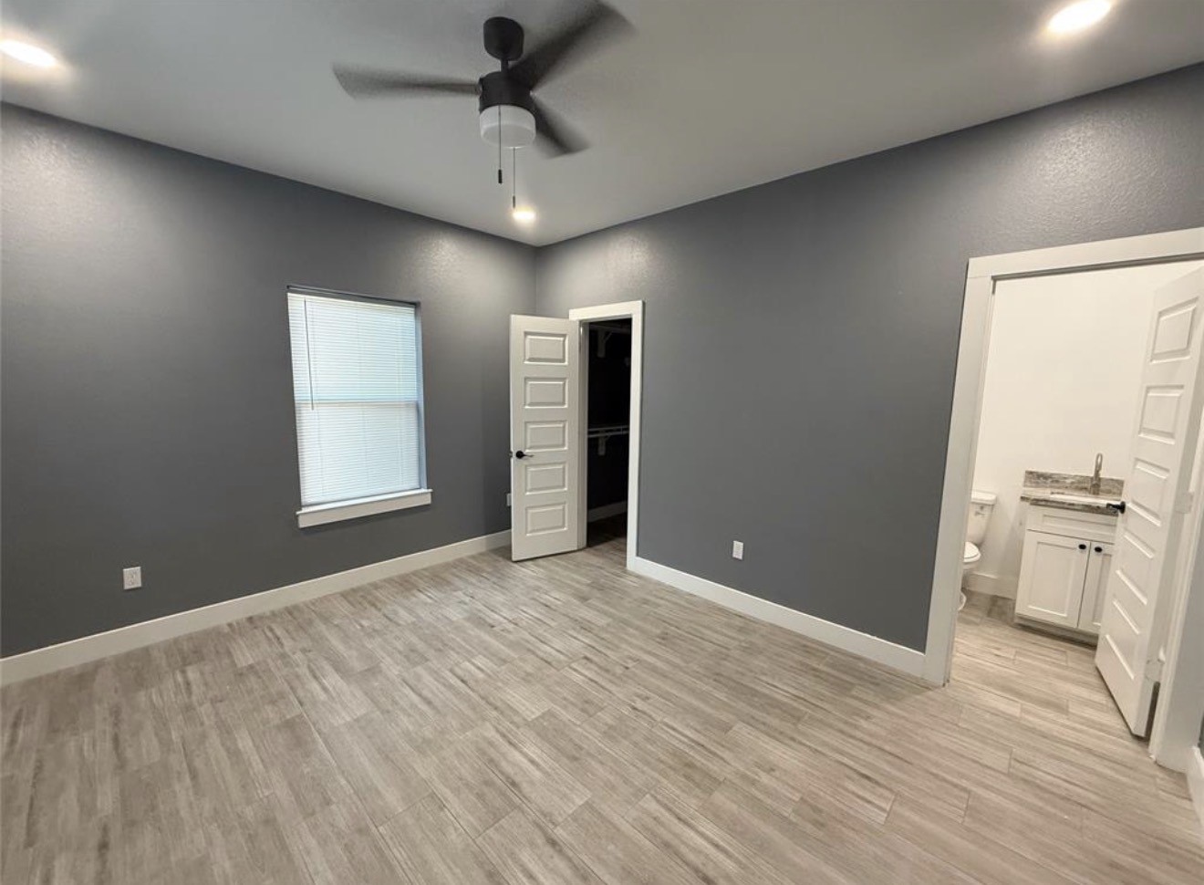 9815 Garcroft Street Houston, TX 77029 - Photo 12 of 14 an empty room with chandelier fan and kitchen view