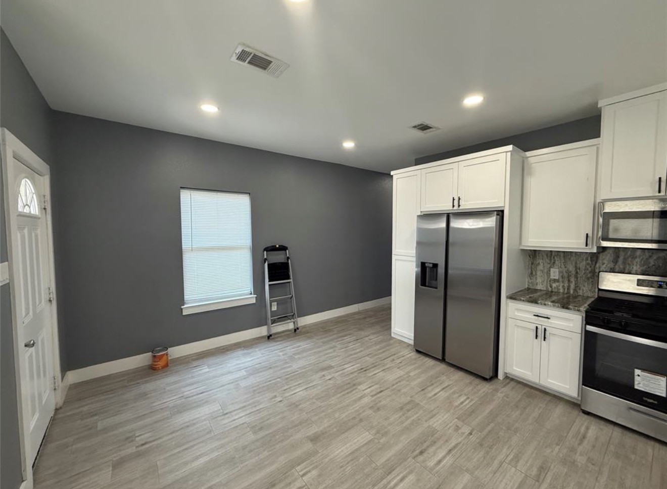 9815 Garcroft Street Houston, TX 77029 - Photo 5 of 14 a view of kitchen with stainless steel appliances granite countertop a refrigerator and a stove top oven