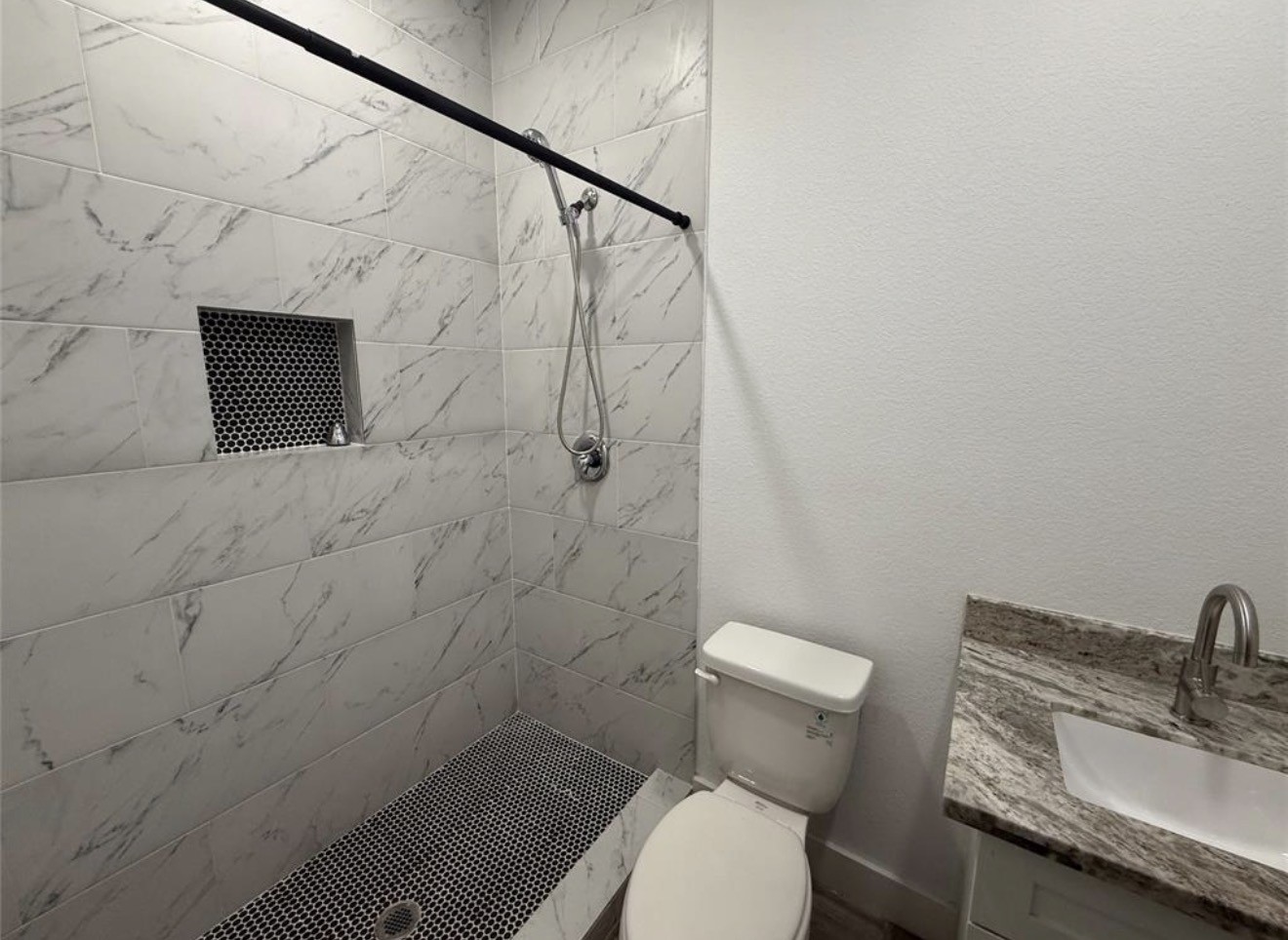 9815 Garcroft Street Houston, TX 77029 - Photo 9 of 14 a bathroom with a toilet and a sink